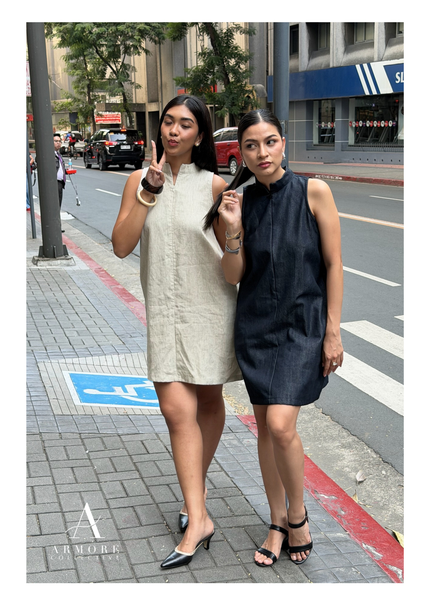 Two women both wearing A-line dresses, one in white and the other in denim