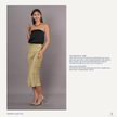 Woman wearing a black tube top and olive green tencel skirt