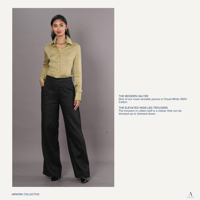 Woman wearing a light olive green polo and black wide-leg trousers 