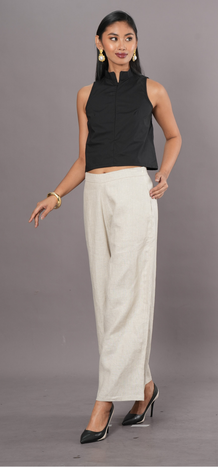 Woman wearing a black sleeveless halter top and wide-leg palazzo pants 