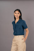 100% Tencel Blue short sleeve polo top with light-colored trousers