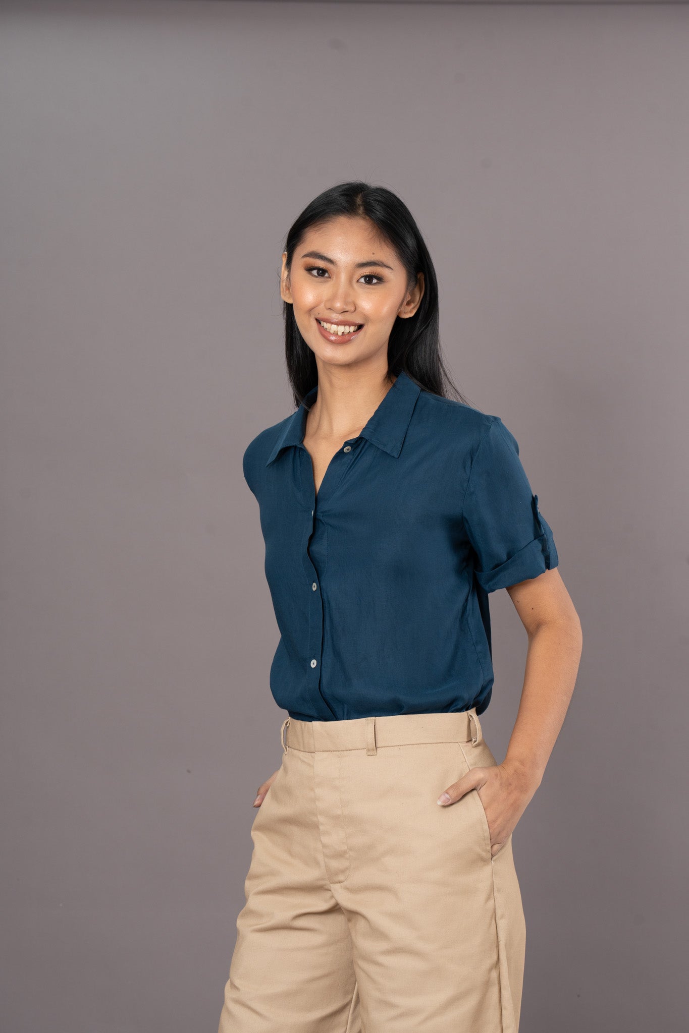 100% Tencel Blue short sleeve polo top with light-colored trousers