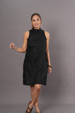 Woman wearing a black sleeveless soft linen A-line dress